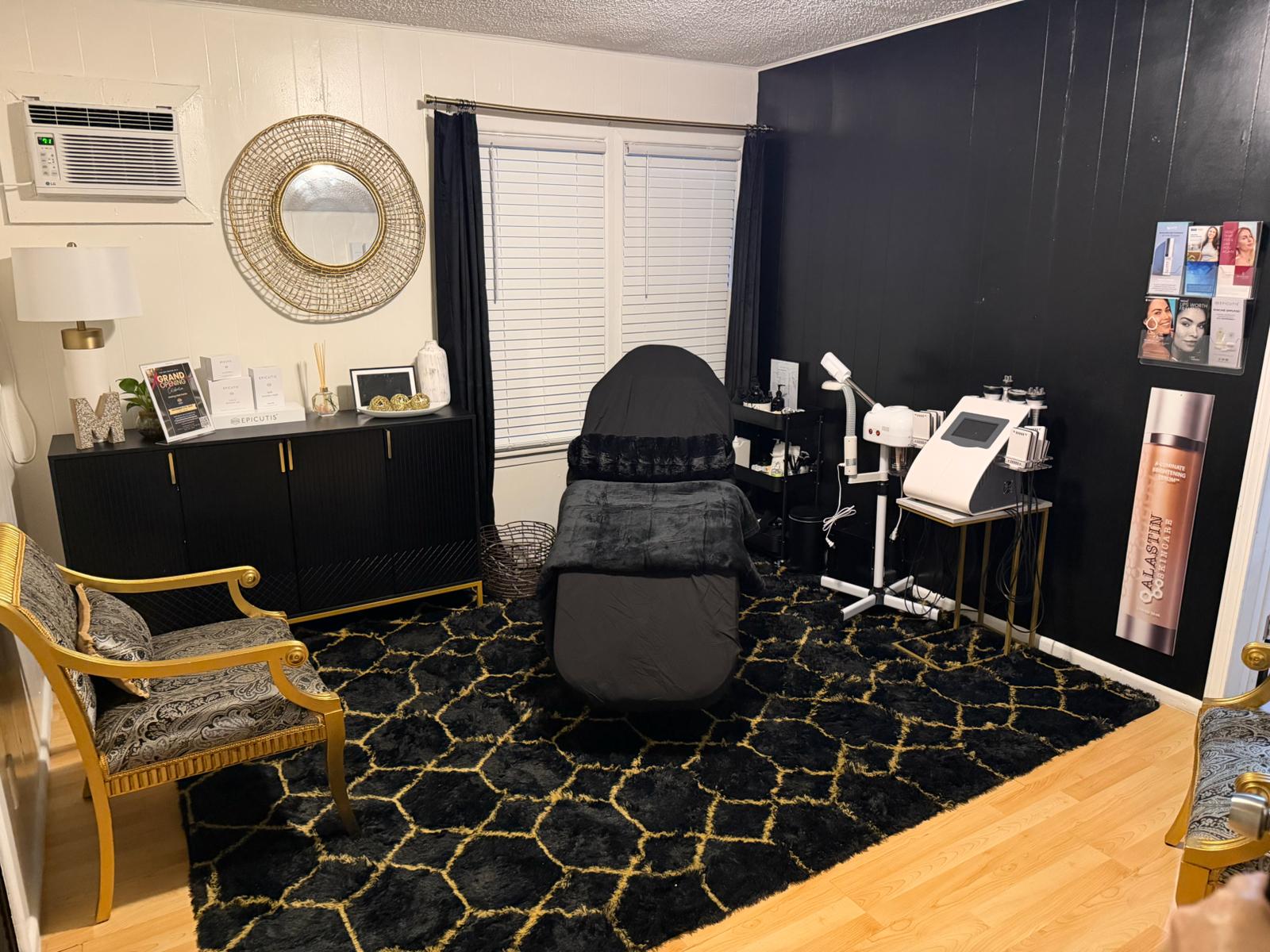 Room with a massage chair, black walls, and decorative elements.